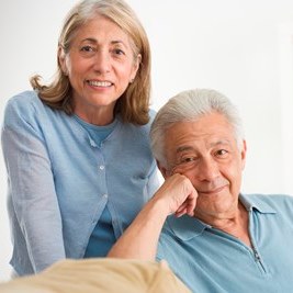 Happy senior couple resting in a sunlit room, illustrating restful sleep after 65